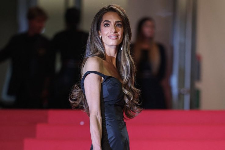 Amal Clooney Shines in Vintage Gold Gown at Cartier Awards, Balancing Glamour with Advocacy